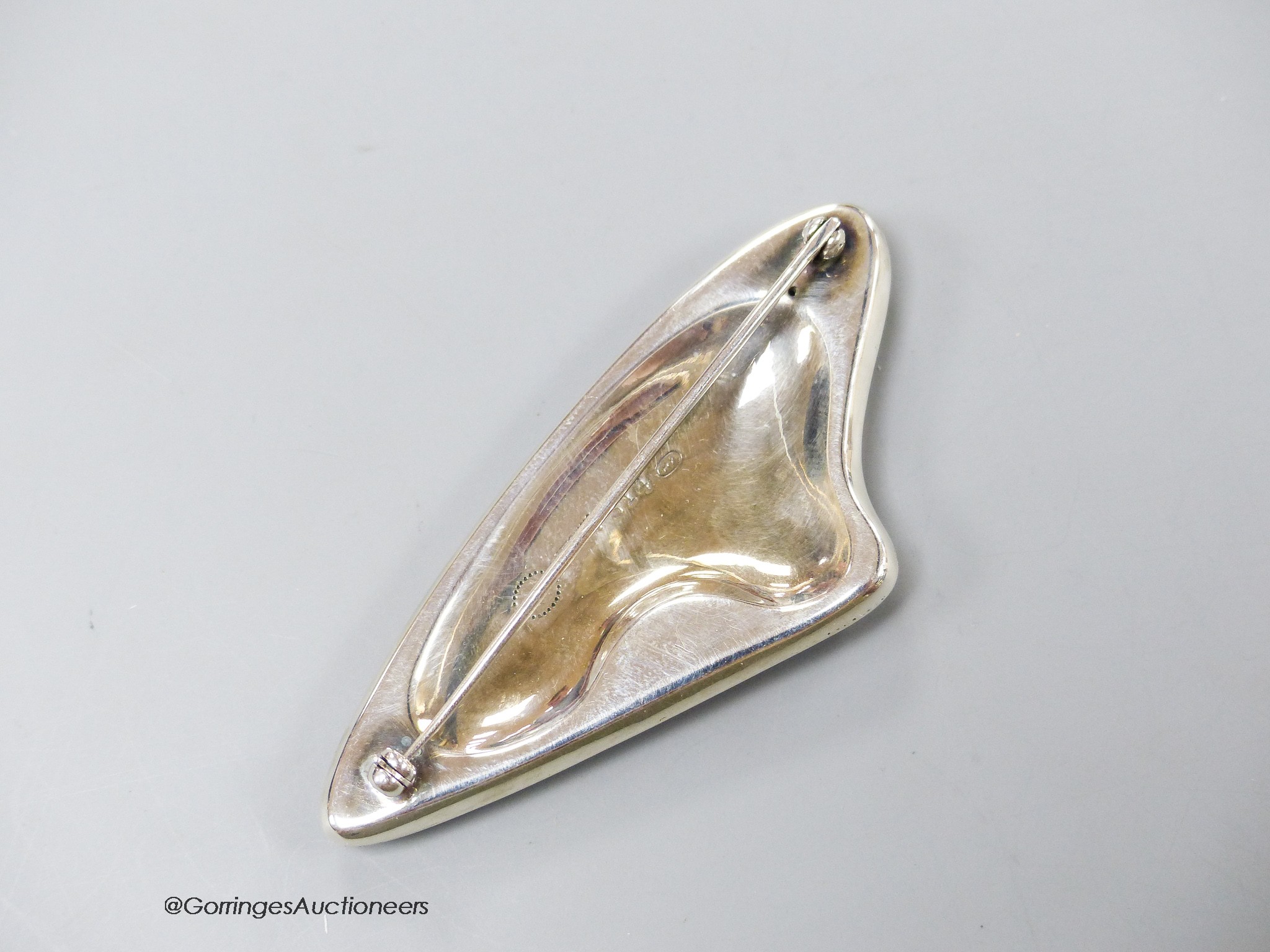 A Georg Jensen sterling and brown enamelled amorphic brooch, designed by Henning Koppel, no.314, 68mm.